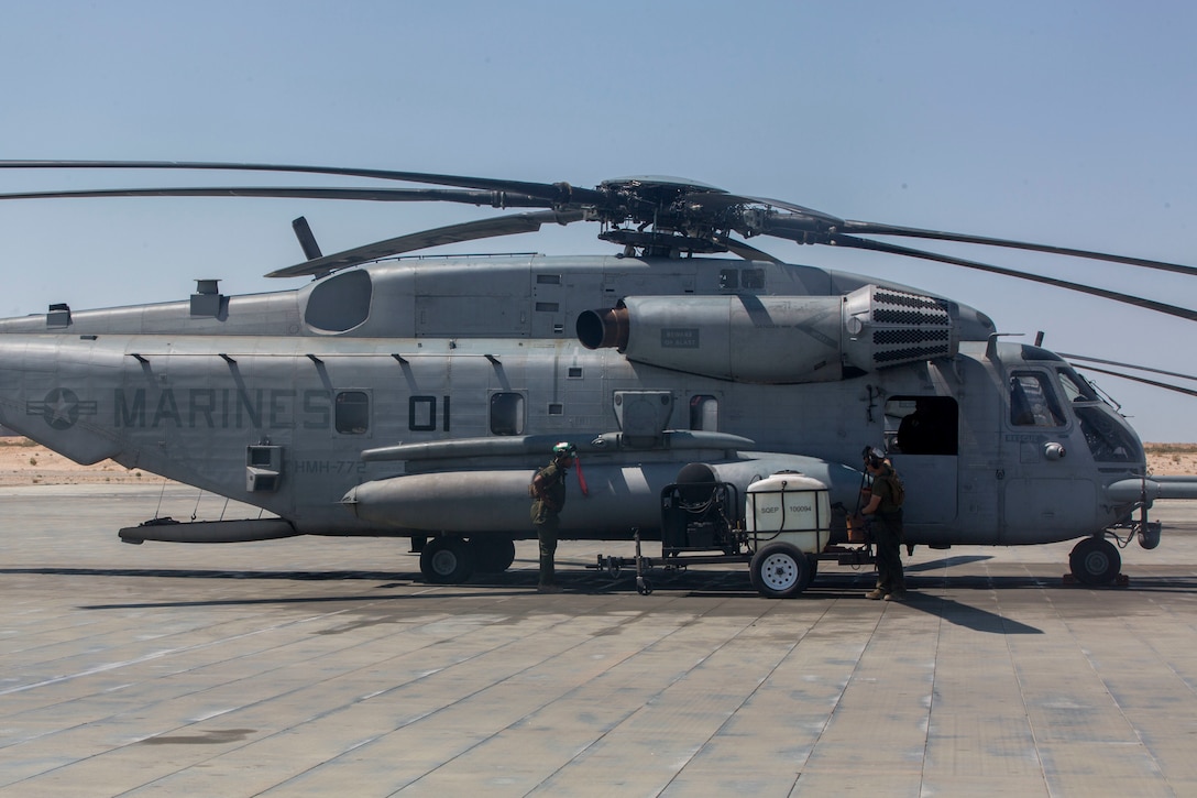 U.S. Marines with Marine Heavy Helicopter Squadron 772, Marine Aircraft Group 49, 4th Marine Aircraft Wing, Marine Forces Reserve, prepare to clean A CH-53E Super Stallion on the airstrip at Camp Wilson, Marine Air Ground Combat Center Twentynine Palms, California, June 21, 2017 in preparation for night missions in support of the 2nd Battalion, 25th Marine Regiment, 4th Marine Division, MARFORRES, final battalion exercise of Integrated Training Exercise 4-17. ITX 4-17 is a live-fire and maneuver combined arms exercise designed to train battalion and squadron-sized units in the tactics, techniques, and procedures required to provide a sustainable and ready operational reserve for employment across the full spectrum of crisis and global engagement. (U.S. Marine Corps photo by Imari J. Dubose)