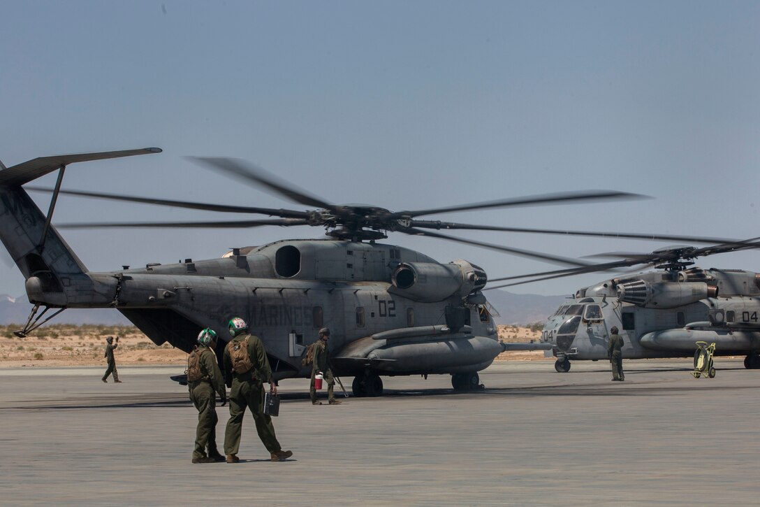 U.S. Marines with Marine Heavy Helicopter Squadron 772, Marine Aircraft Group 49, 4th Marine Aircraft Wing, Marine Forces Reserve, guide two CH-53E Super Stallion transport helicopters on an airstrip at Camp Wilson, Marine Air Ground Combat Center Twentynine Palms, California, June 21, 2017. The squadron prepared for night missions in support of the 2nd Battalion, 25th Marine Regiment, 4th Marine Division, MARFORRES, final battalion exercise of Integrated Training Exercise 4-17.  (U.S. Marine Corps photo by Imari J. Dubose)
