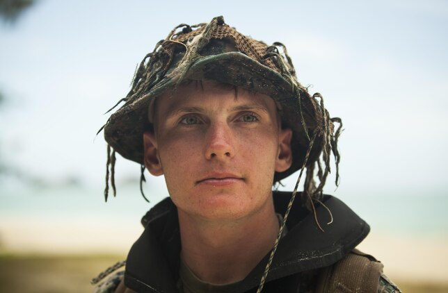 MARINE CORPS TRAINING AREA BELLOWS – Cpl. Kyle Smith, a radio reconnaissance team operator with Radio Reconnaissance Platoon, 3rd Radio Battalion, scans a tree line after swimming two kilometers in the Pacific Ocean during a Radio Reconnaissance Operator’s Course aboard Marine Corps Training Area Bellows, June 15, 2017. For 13 weeks, Marines conducted the Radio Reconnaissance Operator’s Course, utilizing various training areas to prepare themselves when they embed with a reconnaissance platoon. (U.S. Marine Corps photo by Cpl. Jesus Sepulveda Torres)