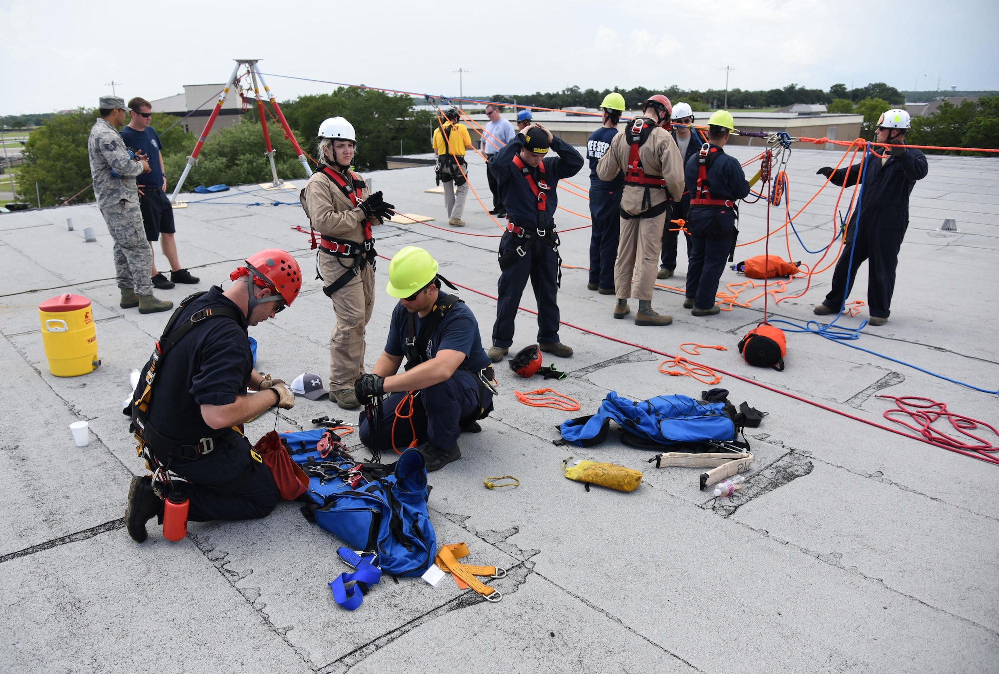 Members of the Keesler and Biloxi Fire Department, prepare to conduct a controlled descent exercise atop of the Weather Training Complex during rope rescue operations training June 14, 2017, on Keesler Air Force Base, Miss. Keesler hosted the advanced rescue certification training course, which consisted of confined space rescue, high and low angle rescue and stokes basket rescue operations. (U.S. Air Force photo by Kemberly Groue)