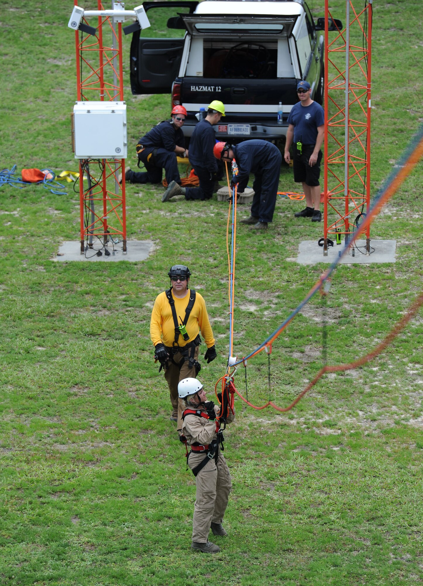 Members of the Keesler and Biloxi Fire Department, participate in a controlled descent exercise atop of the Weather Training Complex during rope rescue operations training June 14, 2017, on Keesler Air Force Base, Miss. Keesler hosted the advanced rescue certification training course, which consisted of confined space rescue, high and low angle rescue and stokes basket rescue operations. (U.S. Air Force photo by Kemberly Groue)