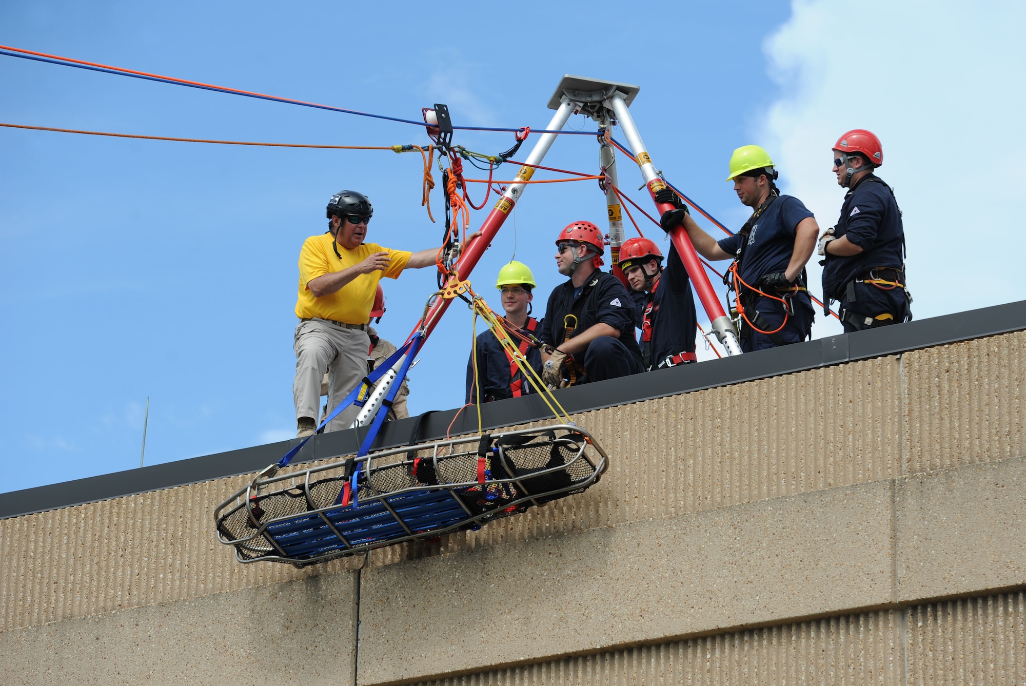 Richard Alfes, instructor and co-owner of Spec Rescue, provides instruction to members of the Keesler and Biloxi Fire Department as they participate in a controlled descent exercise atop of the Weather Training Complex during rope rescue operations training June 14, 2017, on Keesler Air Force Base, Miss. Keesler hosted the advanced rescue certification training course, which consisted of confined space rescue, high and low angle rescue and stokes basket rescue operations. (U.S. Air Force photo by Kemberly Groue)