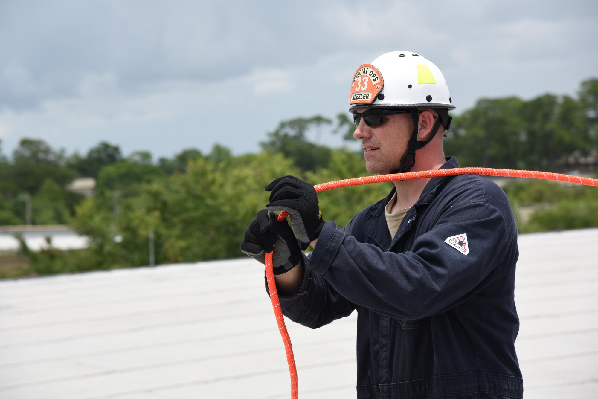 Master Sgt. Brian Malkiewicz, Keesler Firefighter, prepares a rope for a controlled descent exercise atop of the Weather Training Complex during rope rescue operations training June 14, 2017, on Keesler Air Force Base, Miss. Keesler hosted the advanced rescue certification training course, which consisted of confined space rescue, high and low angle rescue and stokes basket rescue operations, for Keesler and Biloxi Firefighters. (U.S. Air Force photo by Kemberly Groue)