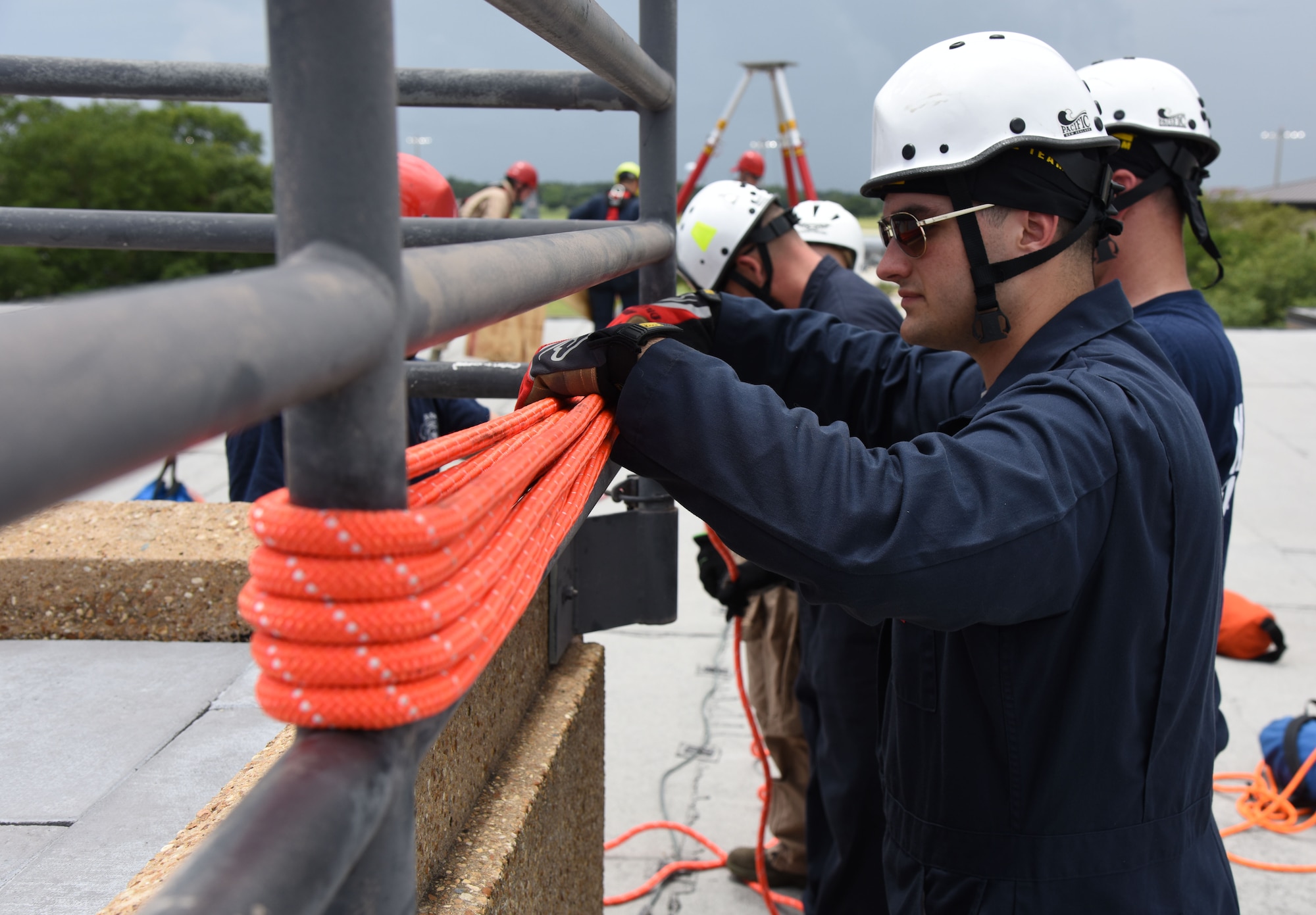 Senior Airman Chase Dillon, Keesler Firefighter, secures a rope for a controlled descent exercise atop of the Weather Training Complex during rope rescue operations training June 14, 2017, on Keesler Air Force Base, Miss. Keesler hosted the advanced rescue certification training course, which consisted of confined space rescue, high and low angle rescue and stokes basket rescue operations, for Keesler and Biloxi Firefighters. (U.S. Air Force photo by Kemberly Groue)