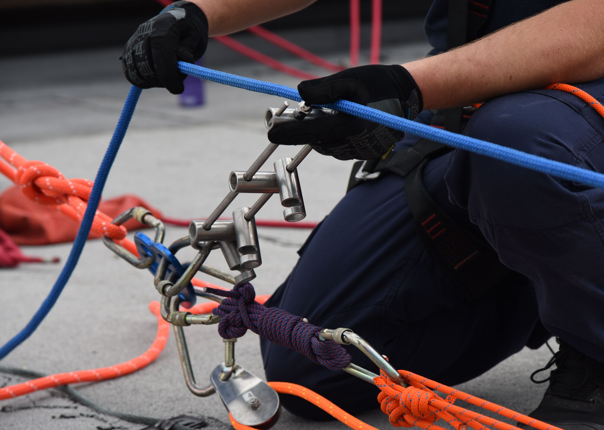 Taylor Beesley, Biloxi Firefighter, secures a rope for a controlled descent exercise atop of the Weather Training Complex during rope rescue operations training June 14, 2017, on Keesler Air Force Base, Miss. Keesler hosted the advanced rescue certification training course, which consisted of confined space rescue, high and low angle rescue and stokes basket rescue operations, for Keesler and Biloxi Firefighters. (U.S. Air Force photo by Kemberly Groue)