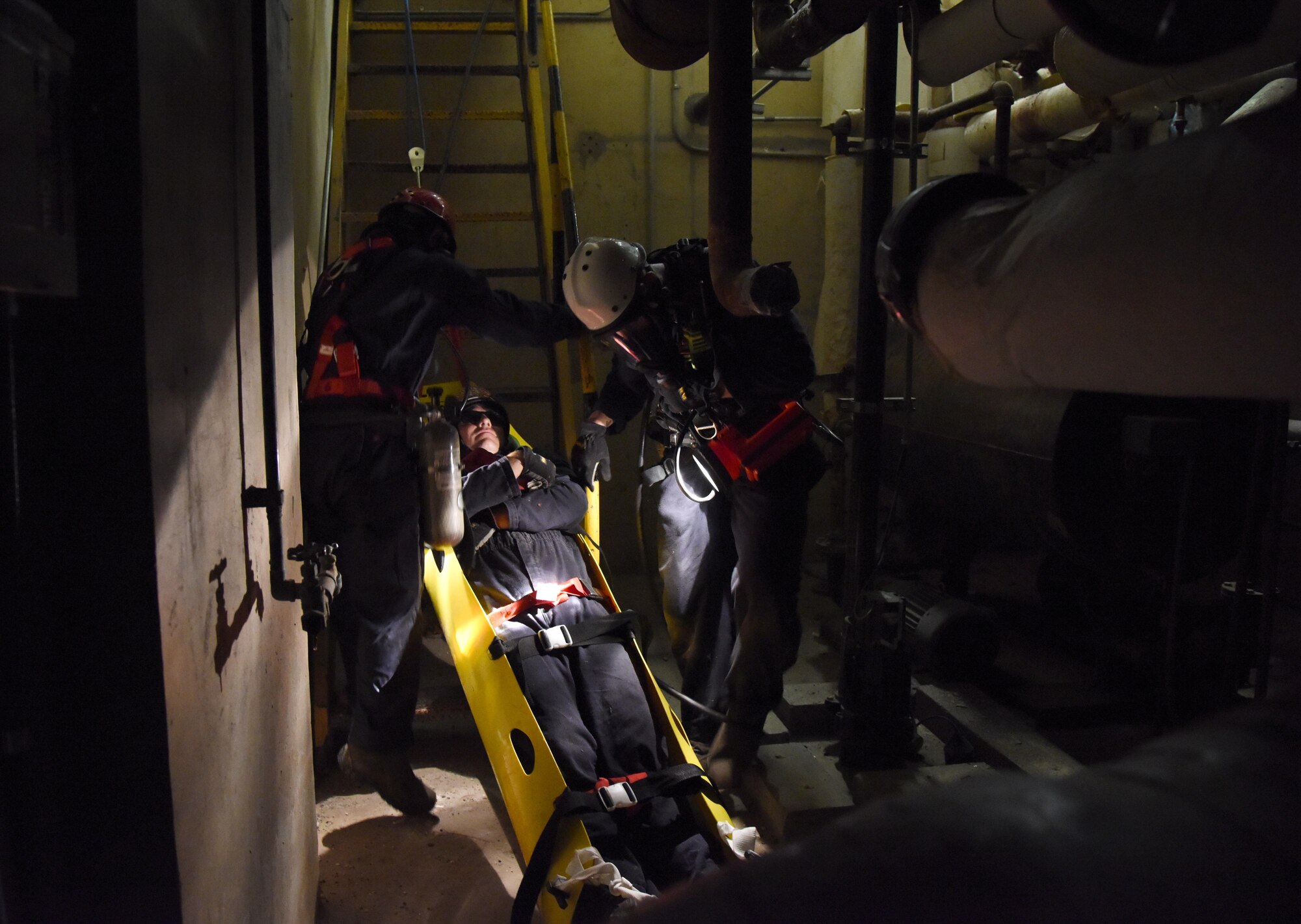 Members of the Keesler and Biloxi Fire Departments participate in confined space rescue operations training in the Keesler Medical Center June 16, 2017, on Keesler Air Force Base, Miss. Keesler hosted the advanced rescue certification training course, which consisted of confined space rescue, high and low angle rescue and stokes basket rescue operations. (U.S. Air Force photo by Kemberly Groue)