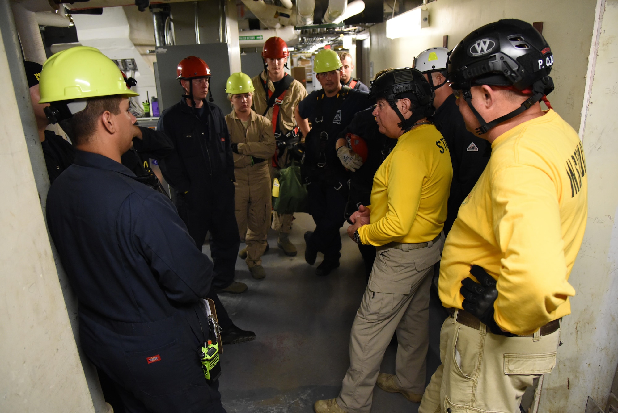 Richard Alfes, instructor and co-owner of Spec Rescue, briefs members of the Keesler and Biloxi Fire Departments as they participate in confined space rescue operations training in the Keesler Medical Center June 16, 2017, on Keesler Air Force Base, Miss. Keesler hosted the advanced rescue certification training course, which consisted of confined space rescue, high and low angle rescue and stokes basket rescue operations. (U.S. Air Force photo by Kemberly Groue)