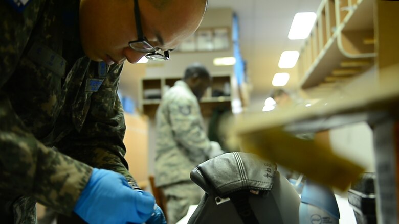 An aircrew flight equipment airman from the Republic of Korea Air Force inspects a pilot’s helmet June 21, 2017, at Eielson Air Force Base, Alaska. Red Flag-Alaska provides an optimal training environment in the Indo-Asia-Pacific Region and focuses on improving ground, space and cyberspace combat readiness and interoperability of U.S. and international forces. (U.S. Air Force photo by Senior Airman Joshua Weaver)