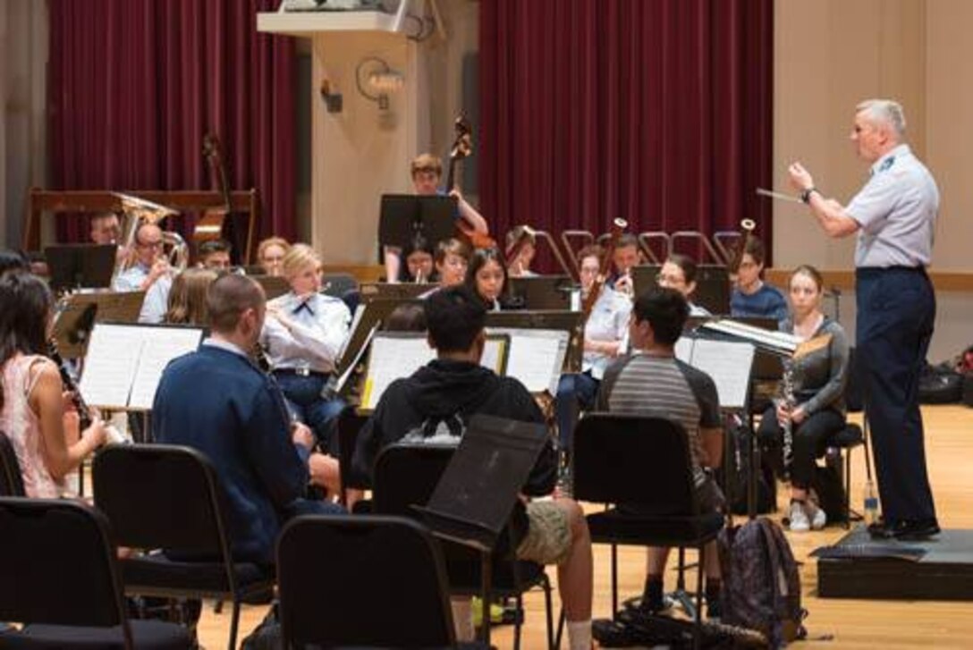 Colonel Larry Lang conducts talented Wind Ensemble students from the Orange County School of the Arts as they play alongside our Concert Band. (U.S. Air Force photos/TSgt Grant Langford/released)