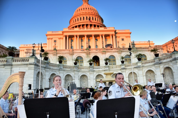 Here, husband and wife team, MSgt and TSgt Rosengaft perform a duet with the band at the Capitol steps on a lovely evening during the band's summer concert series. (U.S. Air Force photos/CMSgt Kamholz/released)