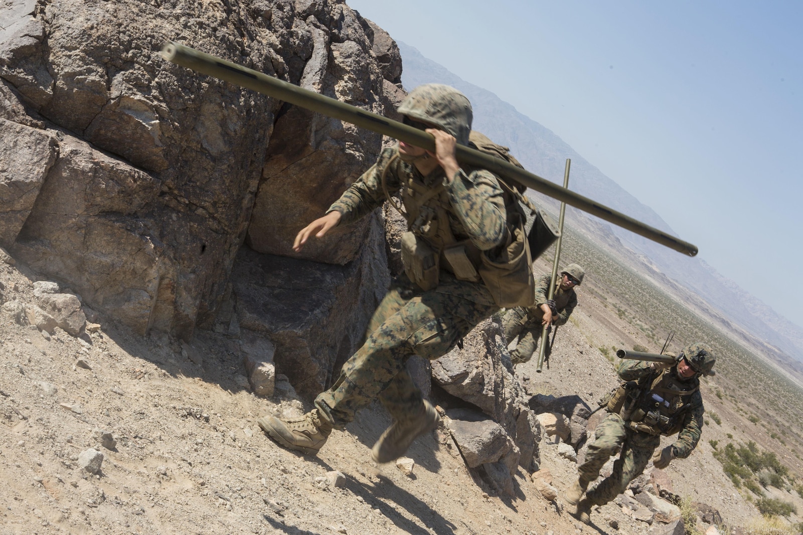 U.S. Marines with Golf Company, 2nd Battalion, 25th Marines, 4th Marine Division, Marine Forces Reserve, carry bangalore torpedos on range 400 during Integrated Training Exercise 4-17 at Camp Wilson, Twentynine Palms, California on June 18, 2017. ITX 4-17 is a live-fire and maneuver combined arms exercise designed to train battalion and squadron-sized units in the tactics, techniques, and procedures required to provide a sustainable and ready operational reserve for employment across the full spectrum of crisis and global engagement.