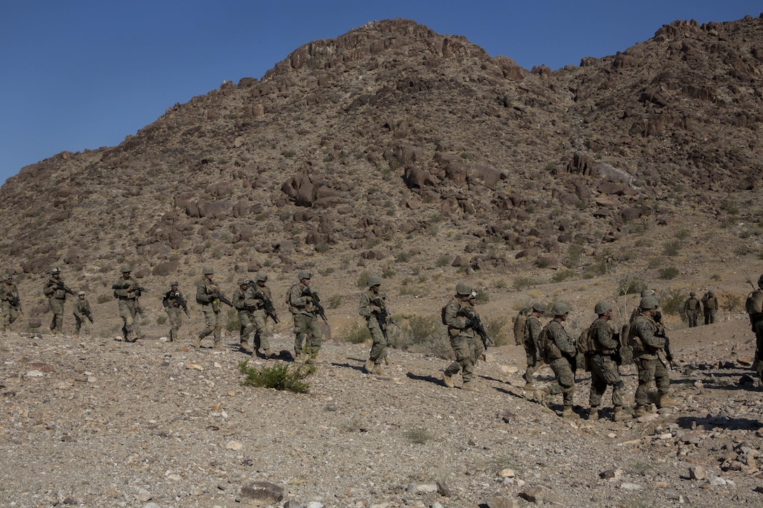 U.S. Marines with Golf Company, 2nd Battalion, 25th Marines, 4th Marine Division, Marine Forces Reserve, hike between objectives at range 400 during Integrated Training Exercise 4-17 at Camp Wilson, Twentynine Palms, California on June 18, 2017. ITX 4-17 is a live-fire and maneuver combined arms exercise designed to train battalion and squadron-sized units in the tactics, techniques, and procedures required to provide a sustainable and ready operational reserve for employment across the full spectrum of crisis and global engagement.