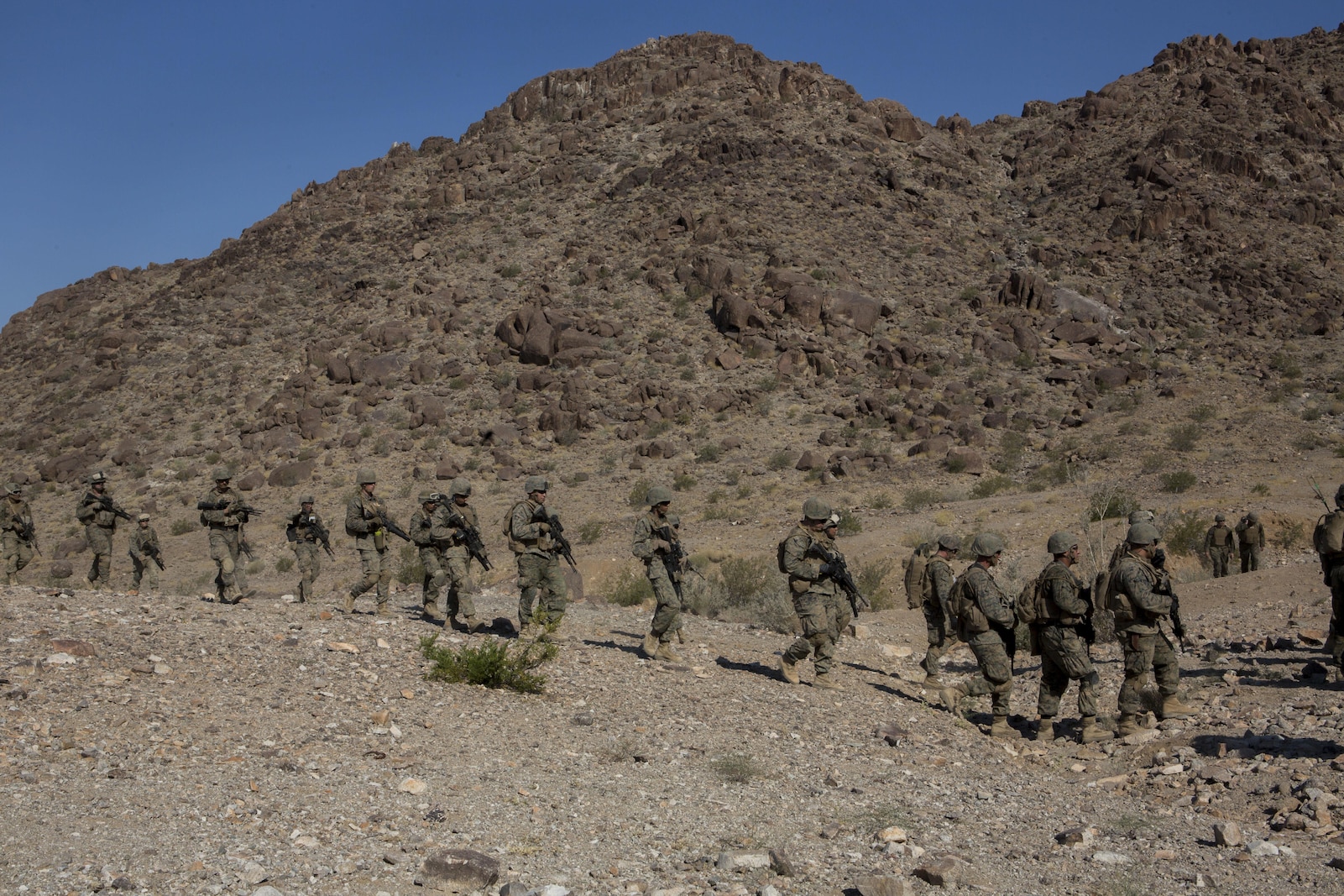 U.S. Marines with Golf Company, 2nd Battalion, 25th Marines, 4th Marine Division, Marine Forces Reserve, hike between objectives at range 400 during Integrated Training Exercise 4-17 at Camp Wilson, Twentynine Palms, California on June 18, 2017. ITX 4-17 is a live-fire and maneuver combined arms exercise designed to train battalion and squadron-sized units in the tactics, techniques, and procedures required to provide a sustainable and ready operational reserve for employment across the full spectrum of crisis and global engagement.