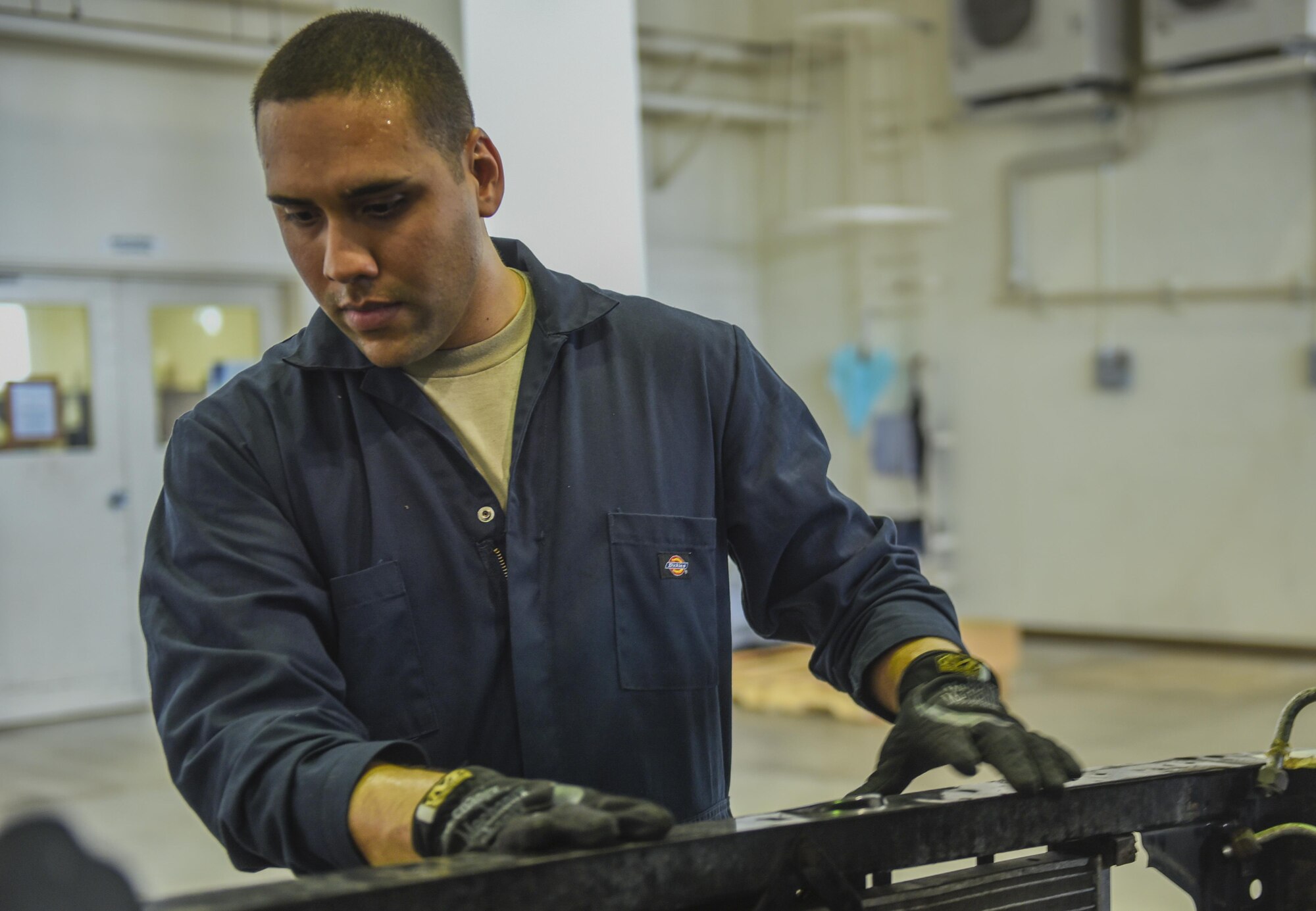 U.S. Air Force Airman 1st Class Kenneth Velez, 18th Mission Support Group vehicle maintainer, replaces parts on an 18th Security Forces Squadron truck in the vehicle maintenance shop June 21, 2017, at Kadena Air Base, Japan. Vehicle maintainers work on several different types of government vehicles, such as 18th SFS patrol cars and 18th Logistics Readiness Squadron buses. (U.S. Air Force photo by Senior Airman Nick Emerick)