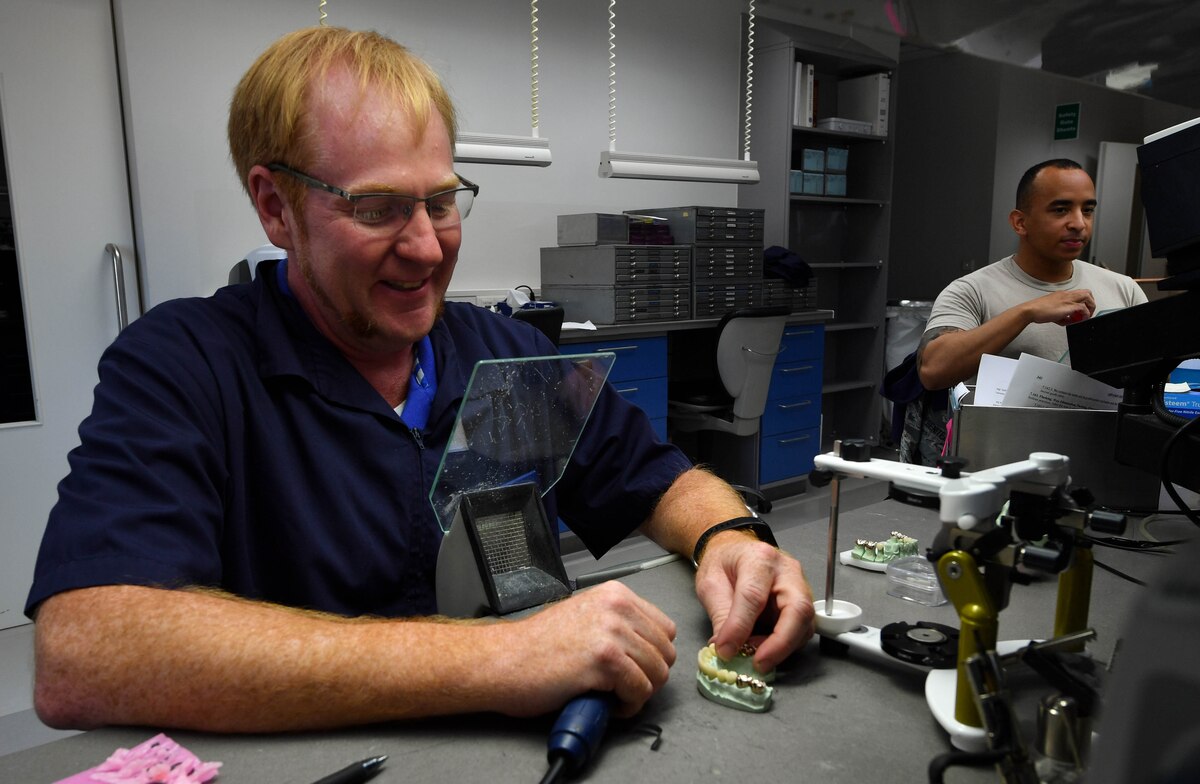 Chris York, 86th Dental Squadron dental lab technician, polishes a porcelain cap for a set made for a U.S. Army Soldier at the 86 DS Area Dental Lab on Ramstein Air Base, Germany, June 21, 2017. The lab has formed a joint partnership with the Army and provides services when needed for Soldiers and their dependents. (U.S. Air Force photo by Senior Airman Tryphena Mayhugh)