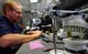A mold of teeth is displayed on a desk as Chris York, 86th Dental Squadron dental lab technician, works on a set of caps for a U.S. Army Soldier at the 86th DS Area Dental Lab on Ramstein Air Base, Germany, June 21, 2017. York made a set of 25 caps for a U.S. Army Soldier is a part of the lab’s joint partnership with their sister service. (U.S. Air Force photo by Senior Airman Tryphena Mayhugh)