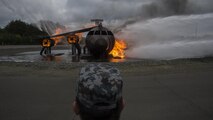 A Japan Air Self-Defense Force civil engineer Airman watches a live-fire demonstration during a bilateral exchange at Misawa Air Base, Japan, June 22, 2017. Building friendships and enhancing mutual understanding were also a contributing factor in this Pacific unity event. After long days of training, U.S. and Japan CE Airmen removed their uniforms and hosted informal dinners to promote international partnerships. (U.S. Air Force photo by Senior Airman Deana Heitzman)