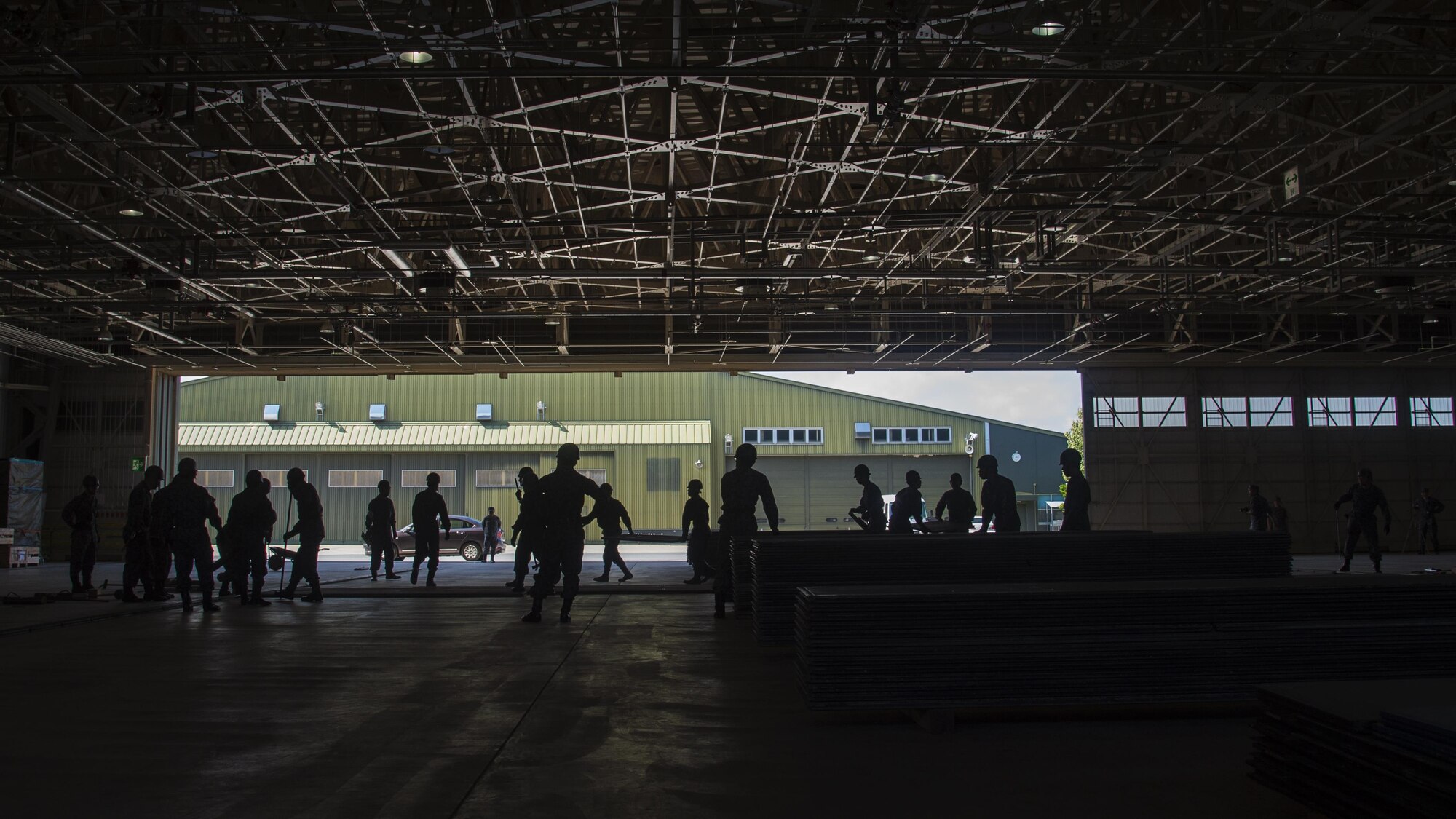 Japan Air Self-Defense Force, civil engineer Airmen conduct a rapid runway repair exhibition during a bilateral exchange event at Misawa Air Base, Japan, June 22, 2017. This is phase two of a RRR, which covers the gravel, or potential aircraft hazards, with AM-2 matting. The exchange focused on base recovery, which ensures infrastructure and airfields remain operational if a natural disaster or an attack occurs. (U.S. Air Force photo by Senior Airman Deana Heitzman)