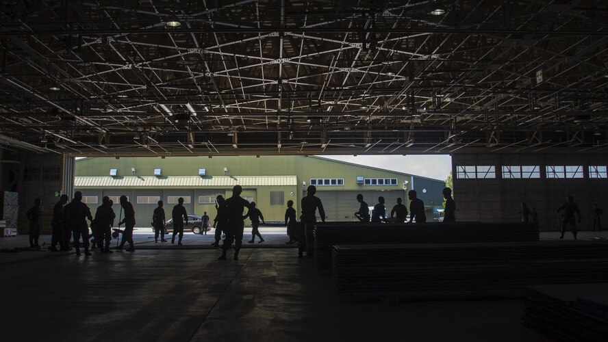 Japan Air Self-Defense Force, civil engineer Airmen conduct a rapid runway repair exhibition during a bilateral exchange event at Misawa Air Base, Japan, June 22, 2017. This is phase two of a RRR, which covers the gravel, or potential aircraft hazards, with AM-2 matting. The exchange focused on base recovery, which ensures infrastructure and airfields remain operational if a natural disaster or an attack occurs. (U.S. Air Force photo by Senior Airman Deana Heitzman)