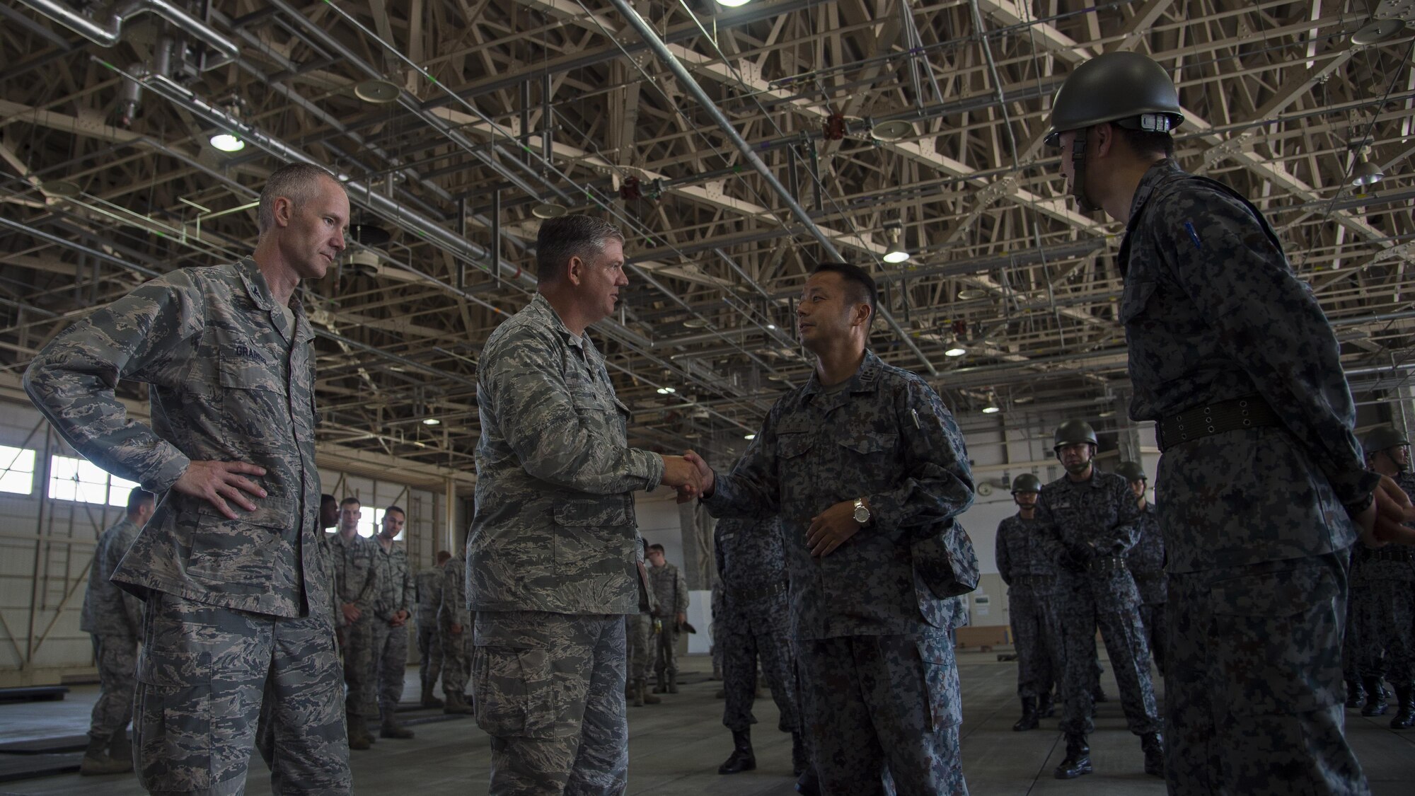 U.S. Air Force Col. Robert Grainger, left, 18th Civil Engineer Group commander at Kadena Air Base, Japan, and Col. Douglas Gilpin, left center, Fifth Air Force logistics, engineering and force protection director at Yokota Air Base, Japan, meets with Japan Air Self-Defense Force civil engineer leadership, right, during a bilateral exchange event at Misawa Air Base, Japan, June 22, 2017. Grainger and Gilpin joined JASDF leadership to share each other’s expertise and experiences with both the JASDF and U.S. Air Force junior Airmen. (U.S. Air Force photo by Senior Airman Deana Heitzman)