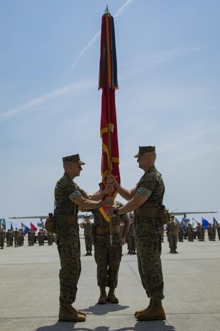 U.S. Marine Corps Col. Mark Palmer, right, Marine Aircraft Group (MAG) 12 commanding officer, receives the MAG-12 unit colors from U.S. Marine Corps Col. Daniel Shipley, left, former MAG-12 commanding officer, during a change of command ceremony at Marine Corps Air Station Iwakuni, Japan, June 23, 2017. Palmer is coming to the air station from Cherry Point, North Carolina, where he served as the 2nd Marine Aircraft Wing Director of Standardization and 2nd MAW Chief of Staff. (U.S. Marine Corps photo by Lance Cpl. Joseph Abrego)