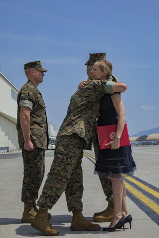 U.S. Marine Corps Maj. Gen. Russell A. Sanborn, left, the commanding general of 1st Marine Aircraft Wing, III Marine Expeditionary Force, hugs Mrs. Kimberly Shipley, right, wife of former Marine Aircraft Group (MAG) 12 commanding officer, after an award presentation, during a change of command ceremony at Marine Corps Air Station Iwakuni, Japan, June 23, 2017. After two years of dedicated service to MAG-12, U.S. Marine Corps Col. Daniel Shipley was relieved of his duties to continue on and serve in Washington D.C. at Headquarters Marine Corps with Programs and Resources. (U.S. Marine Corps photo by Lance Cpl. Joseph Abrego)