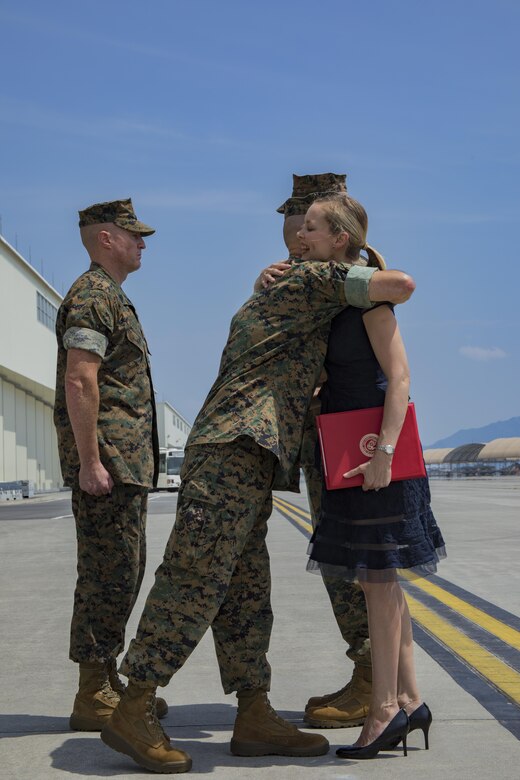 U.S. Marine Corps Maj. Gen. Russell A. Sanborn, left, the commanding general of 1st Marine Aircraft Wing, III Marine Expeditionary Force, hugs Mrs. Kimberly Shipley, right, wife of former Marine Aircraft Group (MAG) 12 commanding officer, after an award presentation, during a change of command ceremony at Marine Corps Air Station Iwakuni, Japan, June 23, 2017. After two years of dedicated service to MAG-12, U.S. Marine Corps Col. Daniel Shipley was relieved of his duties to continue on and serve in Washington D.C. at Headquarters Marine Corps with Programs and Resources. (U.S. Marine Corps photo by Lance Cpl. Joseph Abrego)
