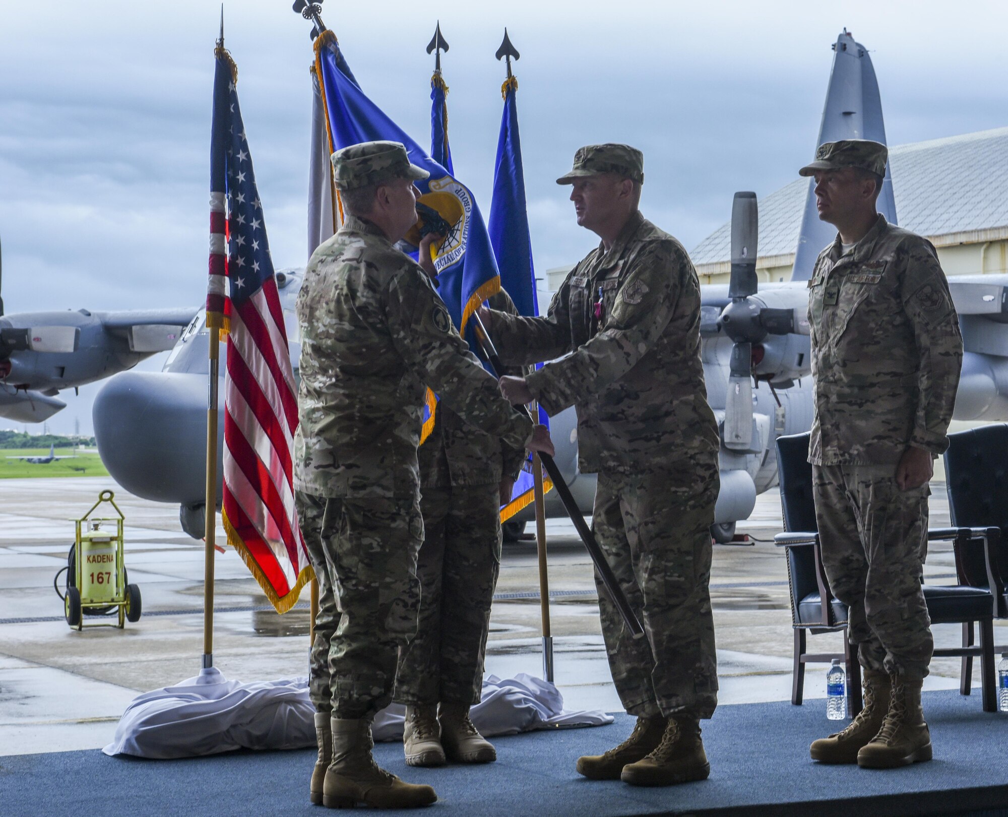 U.S. Air Force Col. William Freeman, outgoing commander of the 353rd Special Operations Group, symbolically passes the guidon to U.S. Air Force Lt. Gen. Brad Webb, commander of Air Force Special Operations Command, to signify the end of his command during a change of command ceremony, June 19, 2017 at Kadena Air Base, Japan. The ceremony is a time-honored tradition in which one officer relinquishes command and passes it to another. (U.S. Air Force photo by Senior Airman Nicholas Emerick)
