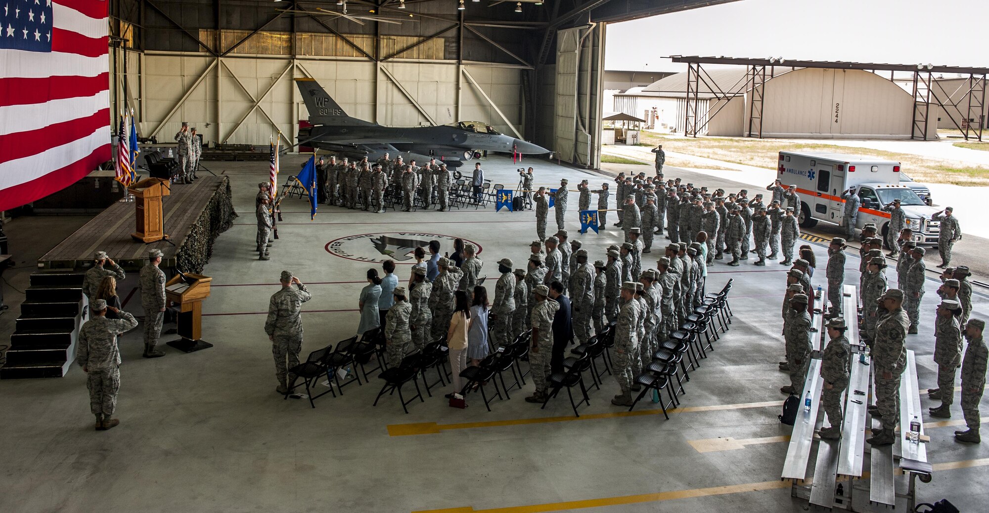 U.S. Air Force Col. David Shoemaker, 8th Fighter Wing commander, Col. Lisa A. Davison, 8th Medical Group outgoing commander, and Col. Joann V. Palmer, 8th MDG incoming commander, salute during a change of command ceremony at Kunsan Air Base, Republic of Korea, June 23, 2017. During the ceremony, Davison relinquished command of the 8th MDG to Palmer. (U.S. Air Force photo by Senior Airman Colville McFee/Released)