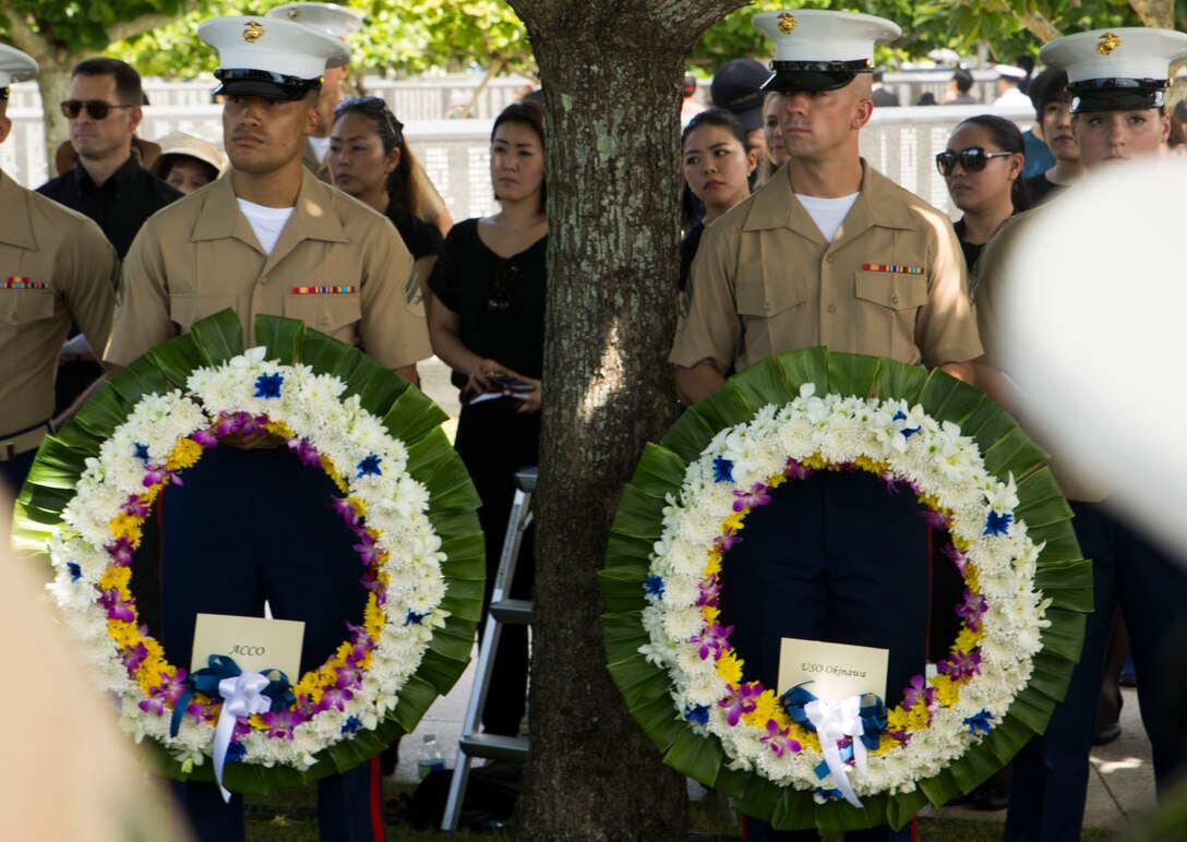U.S. Marines stand by to place wreaths on the Cornerstone of Peace during the 2017 Okinawa Memorial Day services June 23, 2017 at Peace Memorial Park, Itoman, Japan. Service members and Okinawan residents came together to place wreaths as a tribute to all who lost their lives in the Battle of Okinawa. During the ceremony all who attended stood for a moment of silence honoring those that gave the ultimate sacrifice for their country. (U.S. Marine Corps photo by Lance Cpl. Charles Plouffe) 