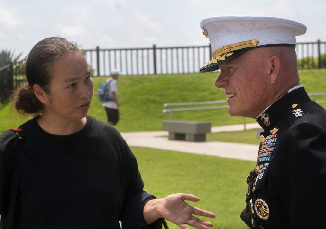 Lt. Gen. Lawrence D. Nicholson speaks with a Okinawan resident at the Cornerstone of Peace during the 2017 Okinawa Memorial Day services June 23, 2017 at Peace Memorial Park, Itoman, Japan. The ceremony brought together service members and Okinawan residents to honor all who lost their lives in the Battle of Okinawa. The memorial walls are inscribed with over 240,000 names of people who died, regardless of nationality, civilian or military status in the battle. During the ceremony all who attended stood for a moment of silence honoring those that gave the ultimate sacrifice for their country. Nicholson is the Marine Forces Pacific commanding general and the Okinawa Area Coordinator. (U.S. Marine Corps photo by Lance Cpl. Charles Plouffe)