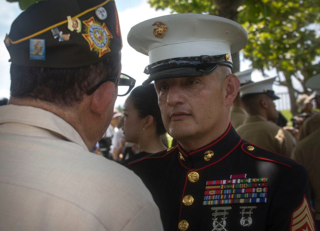 Sgt. Maj. Mario A. Marquez speaks with a member of the Veterans of Foreign Wars during the 2017 Okinawa Memorial Day services June 23 at Peace Memorial Park, Itoman, Japan. The ceremony brought together service members and Okinawan residents to honor all who lost their lives in the Battle of Okinawa. The memorial walls are inscribed with over 240,000 names of people who died, regardless of nationality, civilian or military status in the battle. During the ceremony all who attended stood for a moment of silence honoring those who gave the ultimate sacrifice for their country. Marquez, a Lakewood, California native, is the III Marine Expeditionary Force sergeant major. (U.S. Marine Corps photo by Lance Cpl. Charles Plouffe) 