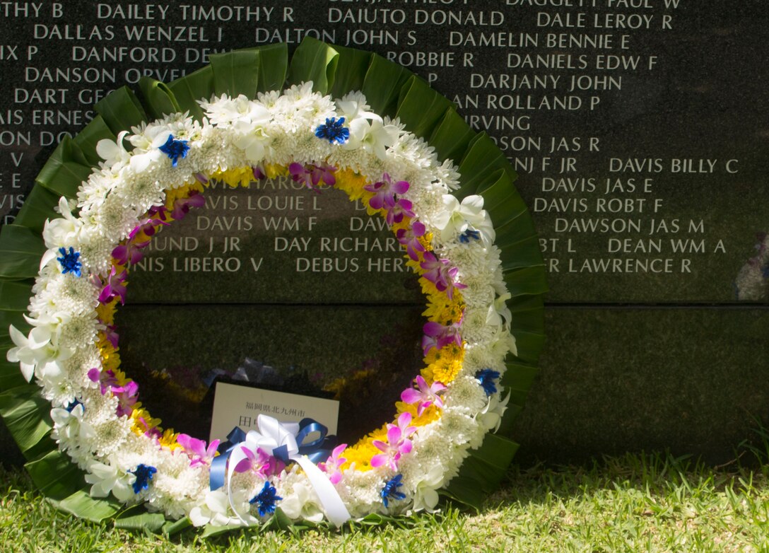 A wreath leans up against the Cornerstone of Peace memorial wall during the 2017 Okinawa Memorial Day services June 23, 2017 at Peace Memorial Park, Itoman, Japan. Service members and Okinawan residents came together to place wreaths as a tribute to all who lost their lives in the Battle of Okinawa. During the ceremony all who attended stood for a moment of silence honoring those who gave the ultimate sacrifice for their country. (U.S. Marine Corps photo by Lance Cpl. Charles Plouffe) 