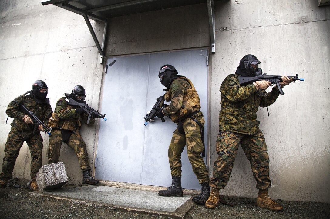U.S. Marines and sailors with Marine Rotational Force 17.1 and soldiers with Norwegian Home Guard 12 prepare to enter a building during a room-clearing exercise near Stjordal, Norway, May 24, 2017. This exercise compared the standard operating procedures for Marines and Norwegian forces in the event of an active shooter or hostage negotiation. Marine Corps photo by Cpl. Emily Dorumsgaard