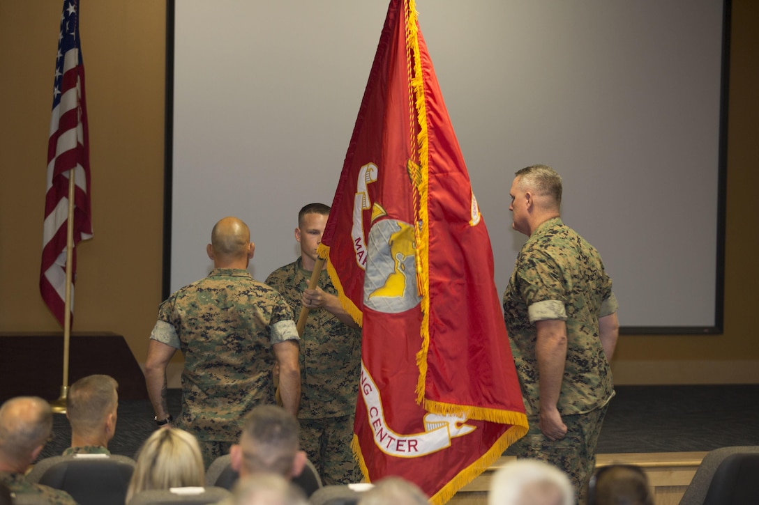 U.S. Marine Col. Brett Bourne, commanding officer, Marine Raider Training Center, with Master Gunnery Sgt. Jerome Root, MRTC senior enlisted advisor,  uncase the new MRTC colors during a redesignation ceremony aboard Marine Corps Base Camp Lejeune, N.C., June 21, 2017. The Marine Special Operations School was redesignated as the Marine Raider Training Center, reactivating the unit for the first time since the original Marine Raiders were disbanded in 1944. (Marine Corps photo by Sgt. Scott Achtemeier)