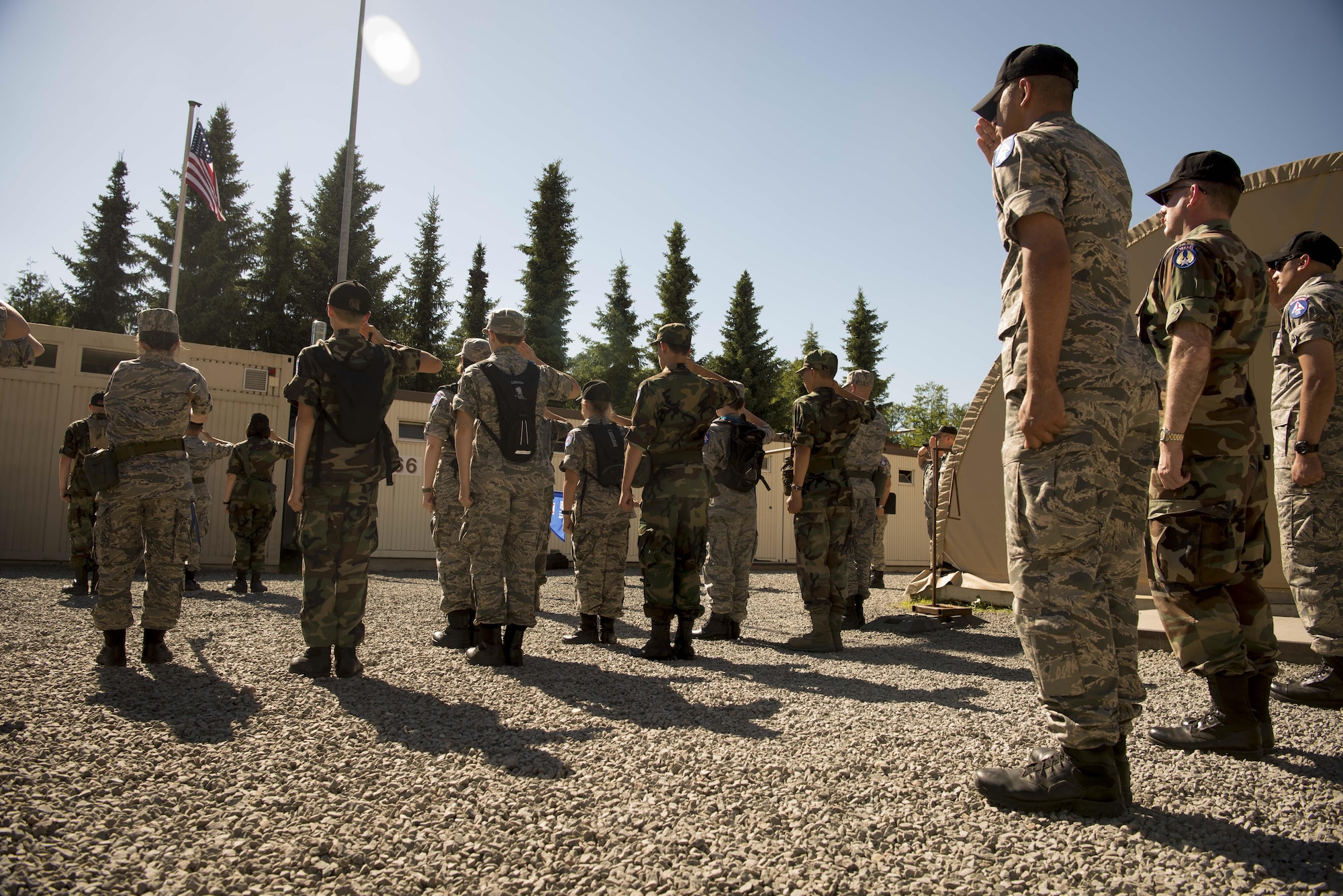 Civil Air Patrol European Encampment cadets salute the flag during Retreat on Ramstein Air Base, Germany, June 19, 2017. The cadets spent more than a week living in deployment tents on Ramstein, carrying out physical and mental tasks in a manner similar to Air Force Basic Training. (U.S. Air Force photo by Senior Airman Elizabeth Baker)