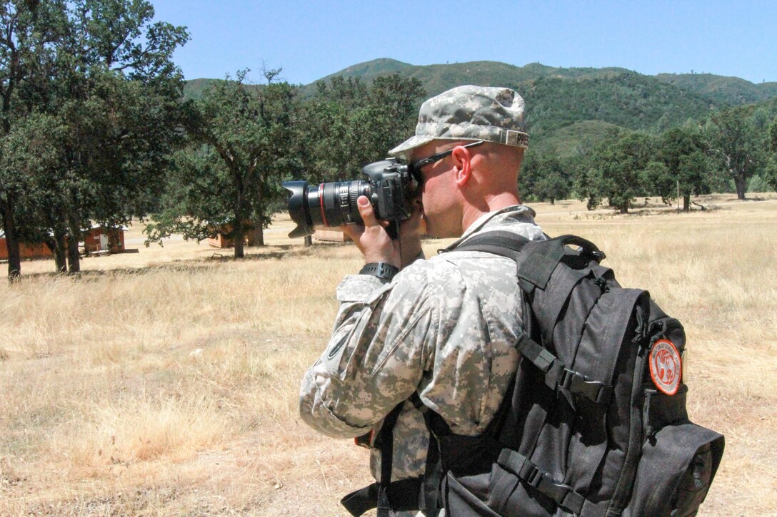 U.S. Army Reserve Capt. Troy Preston makes a photograph during a situational training exercise at Fort Hunter Liggett, Calif. June 17, 2017 while participating in Exercise News Day. The purpose of Exercise News Day is to provide Public Affairs (PA) Soldiers and units with an opportunity to practice their craft in a real-world training environment, improve individual technical skills, and reinforce Mission Essential Task List training while providing PA support for 90% of the Army Reserve’s summer annual training exercises. U.S. Army photo by Capt. Patrick Cook.