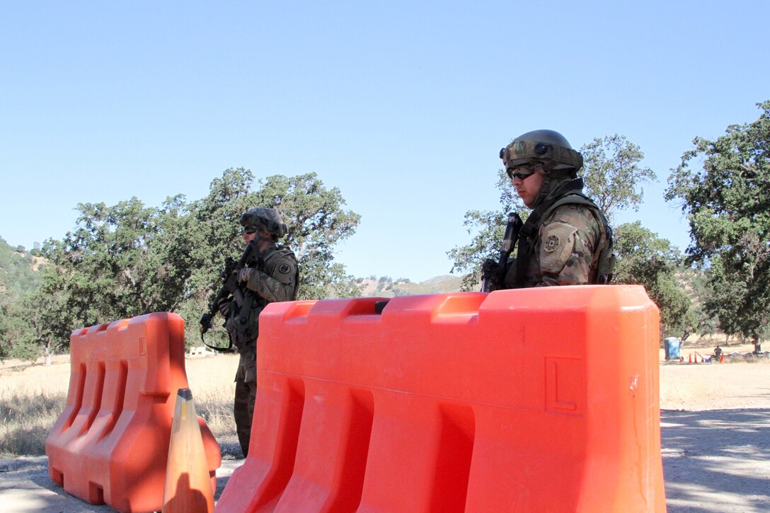 U.S. Army Reserve Spc. Eduardo Cervantes and Spc. Michael DeGeorge of the 341st Military Police Company, 200th Military Police Command stand guard at the entrance to their unit's secured site during a situational training exercise at Fort Hunter Liggett, Calif., June 18, 2017.  More than 3000 U.S. Army Reserve soldiers are participating in the 84th Training Command's Warrior Exercise (WAREX) 19-17-03 at Fort Hunter Liggett, Calif.; the WAREX is a large-scale collective training platform to generate capable, lethal and combat ready forces. U.S. Army photo by Capt. Troy Preston.