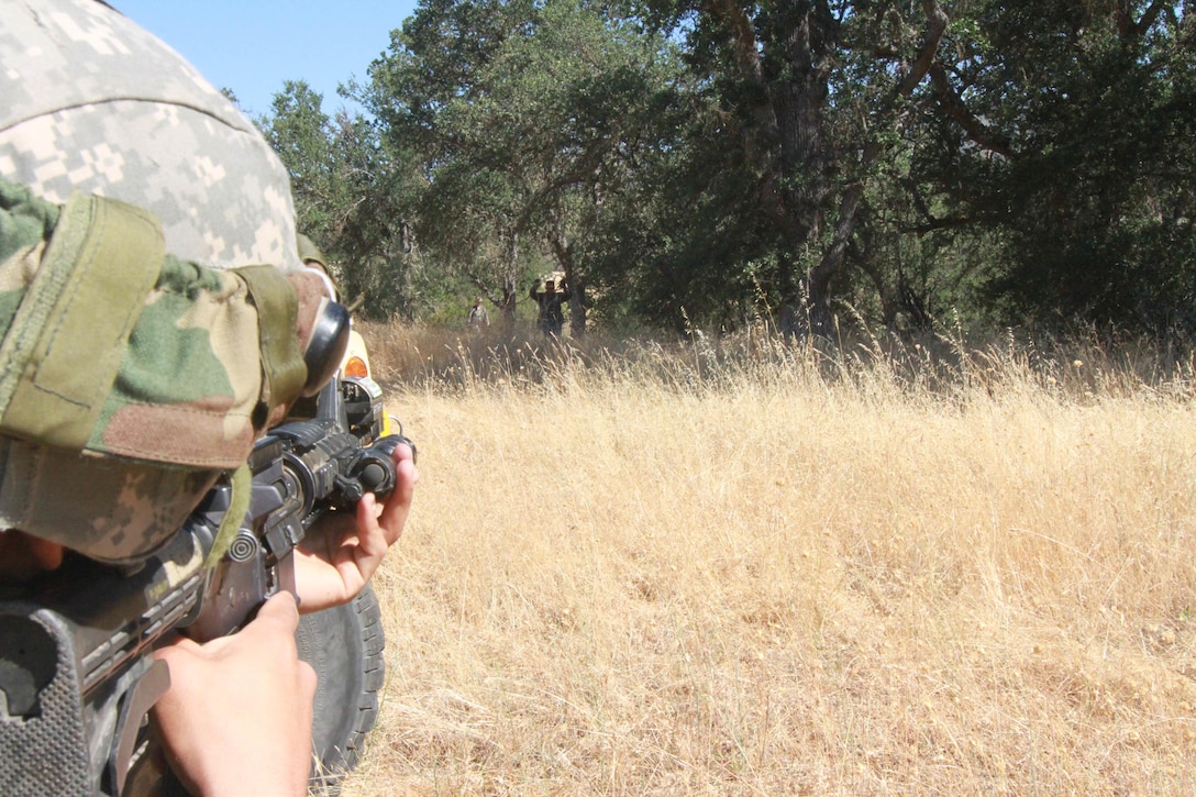 An OPFOR role player surrenders after a simulated firefight with the 341st Military Police Company, 200th Military Police Command at Fort Hunter Liggett, Calif., June 19, 2017. Soldiers from the 341st Military Police Company, 200th Military Police command react to simulated small arms fire during a situational training exercise at Fort Hunter Liggett, Calif., June 19, 2017. More than 3000 U.S. Army Reserve soldiers are participating in the 84th Training Command's Warrior Exercise (WAREX) 19-17-03 at Fort Hunter Liggett, Calif.; the WAREX is a large-scale collective training platform to generate capable, lethal and combat ready forces. U.S. Army photo by Capt. Patrick Cook