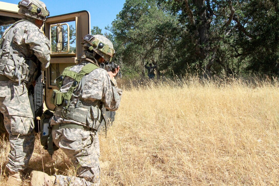 An OPFOR role player surrenders after a simulated firefight with the 341st Military Police Company, 200th Military Police Command at Fort Hunter Liggett, Calif., June 19, 2017. Soldiers from the 341st Military Police Company, 200th Military Police command react to simulated small arms fire during a situational training exercise at Fort Hunter Liggett, Calif., June 19, 2017. More than 3000 U.S. Army Reserve soldiers are participating in the 84th Training Command's Warrior Exercise (WAREX) 19-17-03 at Fort Hunter Liggett, Calif.; the WAREX is a large-scale collective training platform to generate capable, lethal and combat ready forces. U.S. Army photo by Capt. Patrick Cook