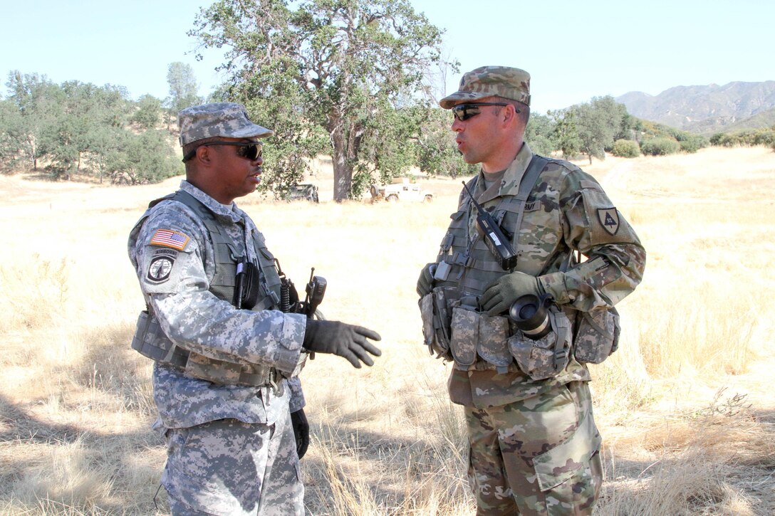 U.S. Army Reserve Capt. Warren Bannister and Sgt. David Tedrow, Observer-Coach-Trainers with the 91st Training Division, 84th Training Command, discuss their observations of the Roational Training Unit that they are training during WAREX 17-03 at Fort Hunter Liggett, Calif., June 19, 2017. More than 3000 U.S. Army Reserve soldiers are participating in the 84th Training Command's Warrior Exercise (WAREX) 19-17-03 at Fort Hunter Liggett, Calif.; the WAREX is a large-scale collective training platform to generate capable, lethal and combat ready forces. U.S. Army photo by Capt. Troy Preston.