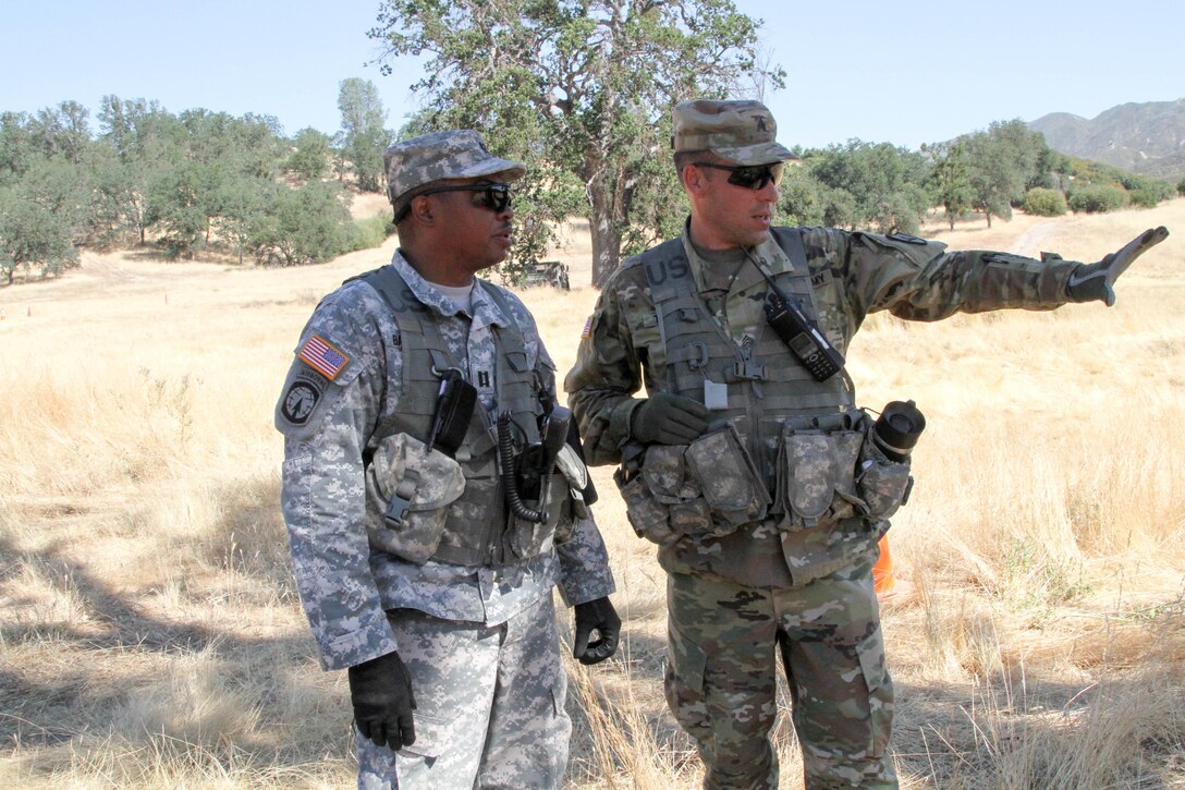 U.S. Army Reserve Sgt. David Tedrow, an Observer-Coach-Trainer with the 91st Training Division, 84th Training Command, explains to Capt. Warren Bannister his observations of the Rotational Training Unit they are both helping to train after a training event during WAREX 17-03 at Fort Hunter Liggett, Calif., June 19, 2017. More than 3000 U.S. Army Reserve soldiers are participating in the 84th Training Command's Warrior Exercise (WAREX) 19-17-03 at Fort Hunter Liggett, Calif.; the WAREX is a large-scale collective training platform to generate capable, lethal and combat ready forces. U.S. Army photo by Capt. Troy Preston.