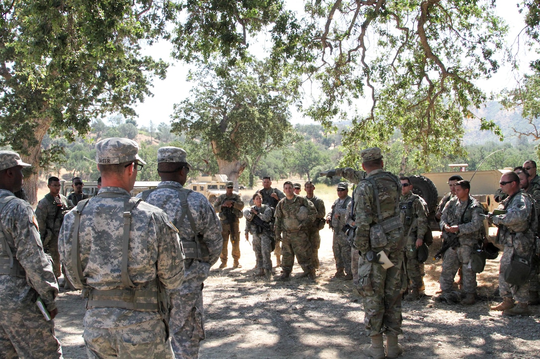 U.S. Army Reserve Sgt. David Tedrow, an Observer-Coach-Trainer with the 91st Training Division, 84th Training Command, conducts an after action review with the 341st Military Police Company, 200th Military Police Command after a base defense exercise as part of WAREX 17-03 at Fort Hunter Liggett, Calif., June 19, 2017. More than 3000 U.S. Army Reserve soldiers are participating in the 84th Training Command's Warrior Exercise (WAREX) 19-17-03 at Fort Hunter Liggett, Calif.; the WAREX is a large-scale collective training platform to generate capable, lethal and combat ready forces. U.S.Army photo by Capt. Troy Preston.