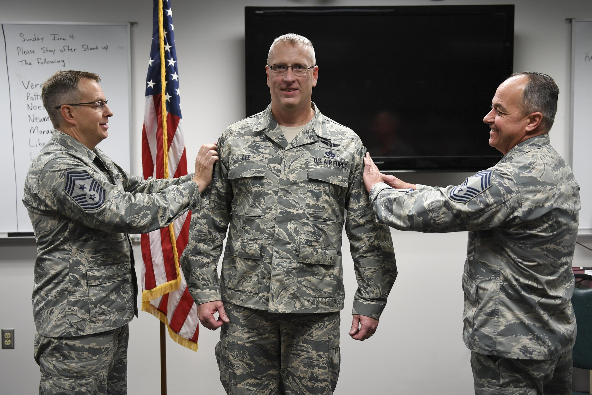 Senior Master Sgt. John Lee, Civil Engineer Manager with the 911th Civil Engineer Squadron, prepares to have stripes tacked onto his uniform at the Pittsburgh International Airport Air Reserve Station, June 4, 2017. Lee was promoted to the rank of Chief Master Sergeant.