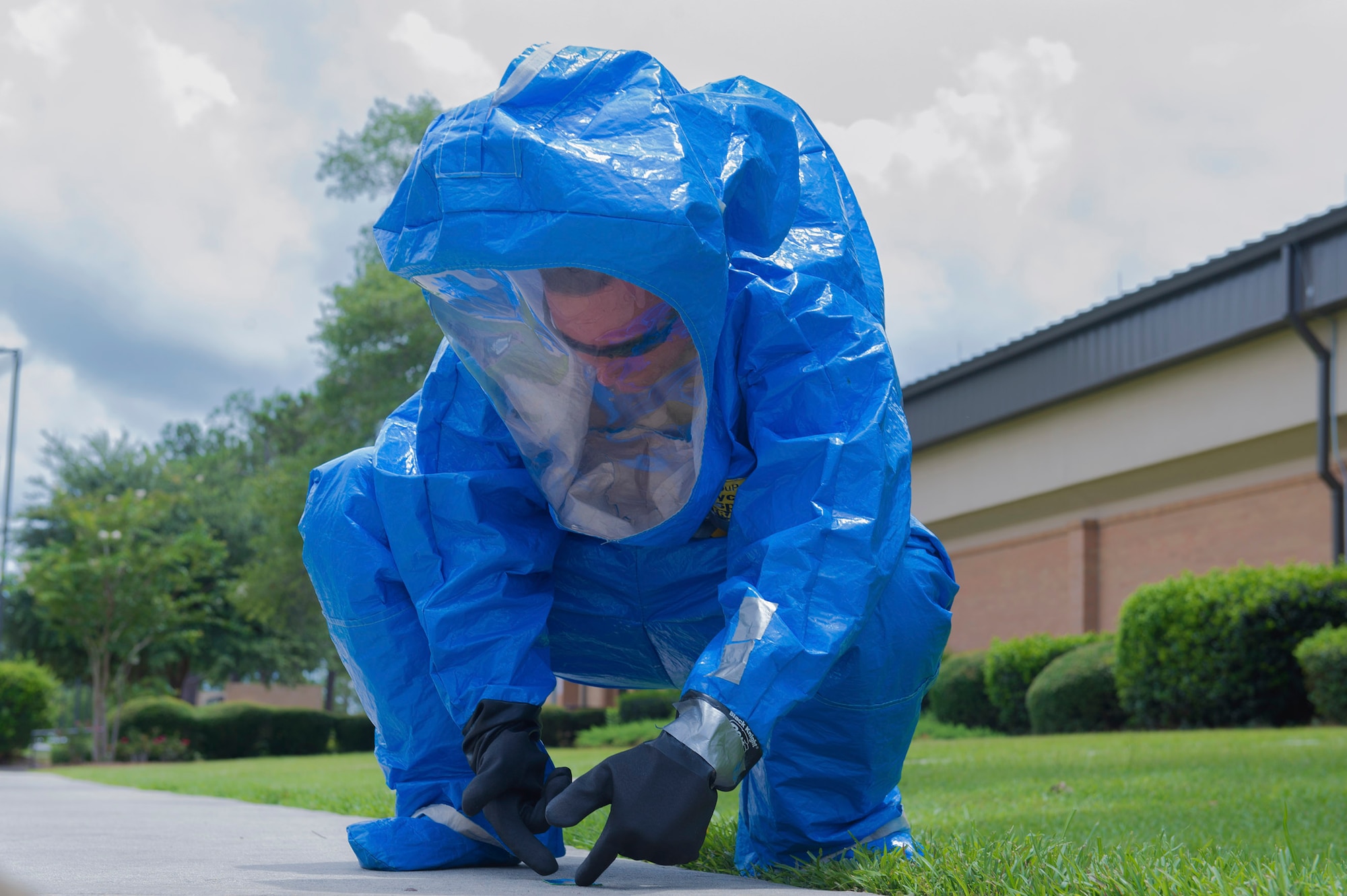 Cadet William Dell, Florida State Detachment 145, picks up hazardous biological material during a simulated exercise as a part of Operation Air Force, June 19, 2017, at Moody Air Force Base, Ga. The annual event is designed to give cadets a hands-on training experience and a glance at various mission assets at bases across the world. The program allows cadets to confirm or reassess their pursued career fields while learning different support functions to become better leaders of Airmen in the future. (U.S. Air Force photo by Senior Airman Greg Nash)