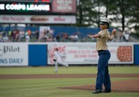 Pfc. Quiozha Alexander, administration clerk, S-1, Headquarters and Service Battalion, U.S. Marine Corps Forces Command, throws the first pitch during the Norfolk Tides’ Marine Corps Appreciation Night, Norfolk, Va., June 17. The annual event was held to honor the Marines who are currently serving and those who have served. (Official U.S. Marine Corps photo by Cpl. Logan Snyder/ Released)