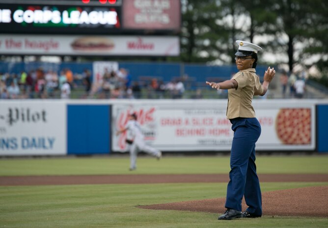 Pfc. Quiozha Alexander, administration clerk, S-1, Headquarters and Service Battalion, U.S. Marine Corps Forces Command, throws the first pitch during the Norfolk Tides’ Marine Corps Appreciation Night, Norfolk, Va., June 17. The annual event was held to honor the Marines who are currently serving and those who have served. (Official U.S. Marine Corps photo by Cpl. Logan Snyder/ Released)