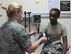 U.S. Air Force Airman 1st Class Hailey Connahey, 7th Medical Operations Squadron medical technician, performs a blood pressure test on  U.S. Air Force Senior Airman Tyra Smith, 7th Logistics Readiness Squadron logistics planner, during the Wing Familiarization Program visit to the 7th Medical Group at Dyess Air Force Base, Texas June 16, 2017. During the month of June 2017, approximately 76 Airmen from the 7th Mission Support Group were given the oppurtunity to participate in the Wing Familiarization Program. (U.S. Air Force photo by Airmen Kylee Thomas)