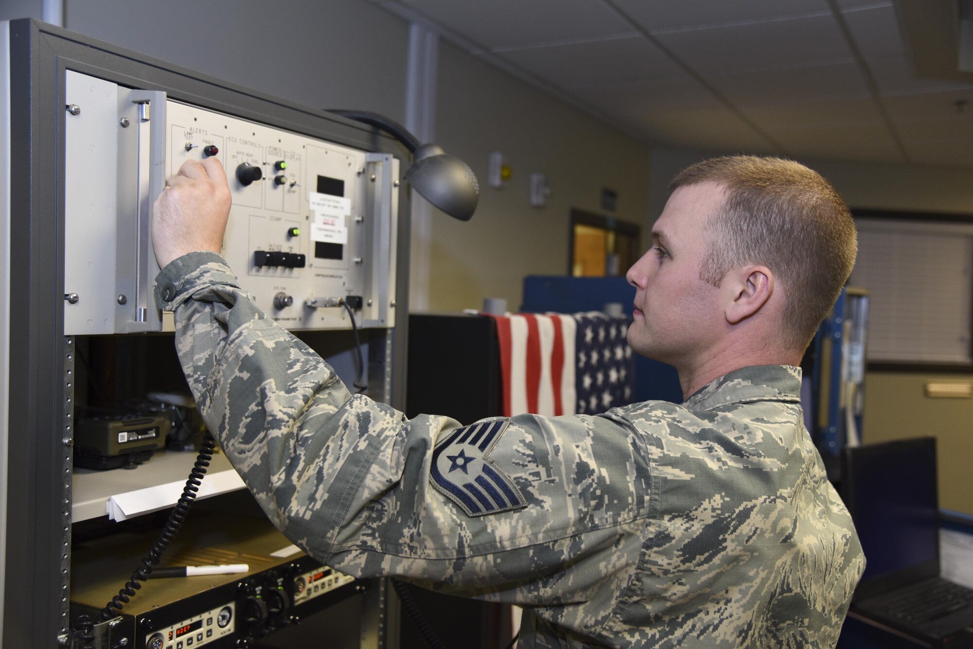 Staff Sgt. Dean Chambers works with equipment in the command post at the 117th Air Refueling Wing June 15, 2017 in Birmingham, Alabama.  Dean, a recent distinguished graduate of technical training at Keesler Air Force Base in Biloxi, Mississippi, is a command and control specialist. (U.S. Air National Guard photo by: Airman 1st Class Lee Murphy)