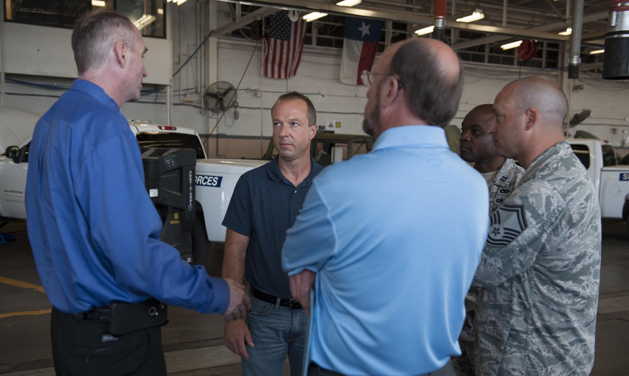 Representatives from Dyess Air Force Base, Arrow Ford and Robins AFB  talk about modifications for the flightline tow tractor, also known as a bobtail vehicle, at Dyess AFB, Texas, June 14, 2017. The 7th Logistics Readiness Squadron vehicle maintenance flight reached out to Arrow Ford to create a solution for the wear and tear of bobtail tires. (U.S. Air Force photo by Airman 1st Class April Lancto)